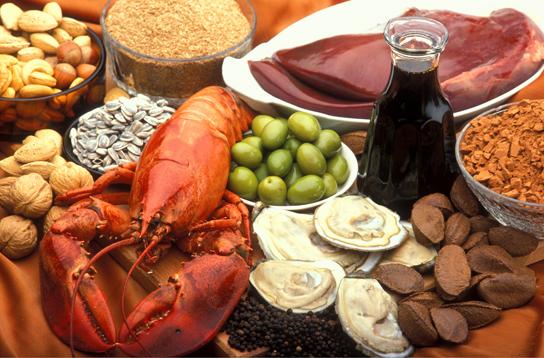 Photo shows a variety of foods, including lobster, clams, nuts and liver.