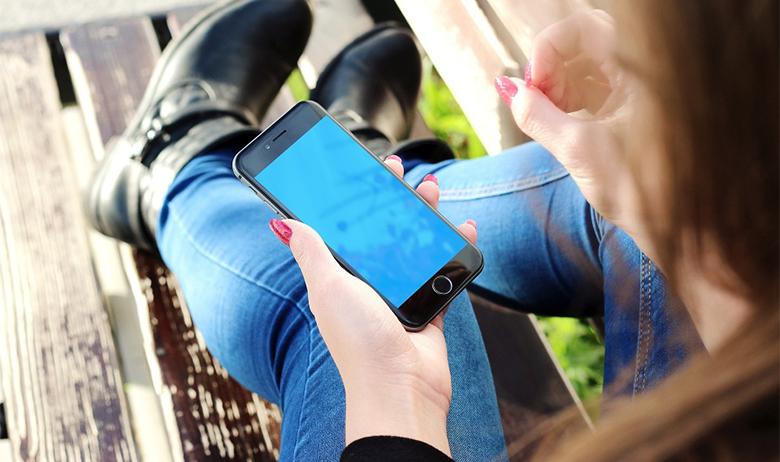 The image is a photograph of the iPhone's home screen.