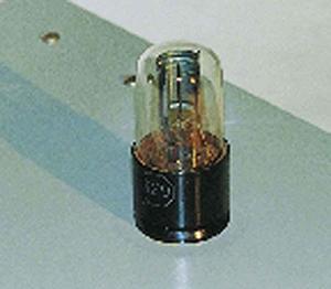 A picture of a lightmeter is shown. There is a clear bulb placed on top of a black base. Inside the bulb is a metal plate attached to a wire. The wire drops into the black base and is no longer visible to the viewer.