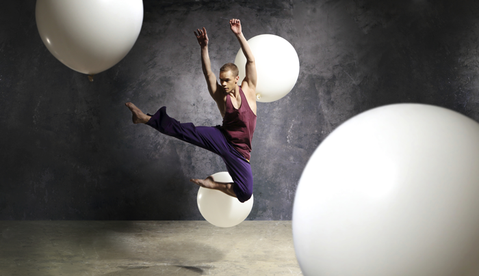 Image of dancer performing on stage with props