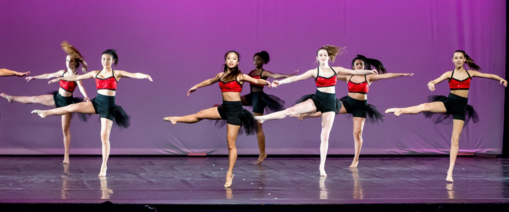 Image of dancers in motion on stage