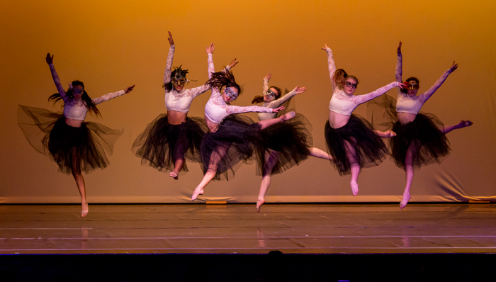 Image of dancers in costume performing on stage