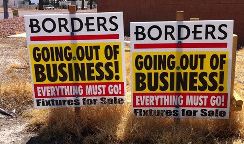 This image is a photograph of a 'Going Out of Business' signs for Borders. The signs denote that even the fixtures are for sale.
