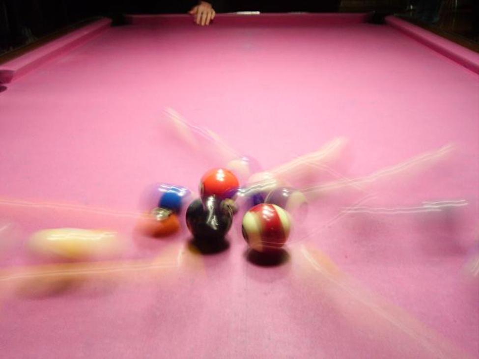 Billiard balls in two-dimensional motion after the initial shot.