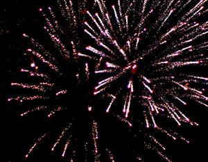 The photograph shows fireworks exploding in the night sky.
