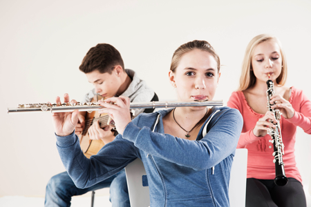 Image of band students playing instruments in a classroom