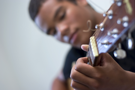 Image of boy playing the guitar