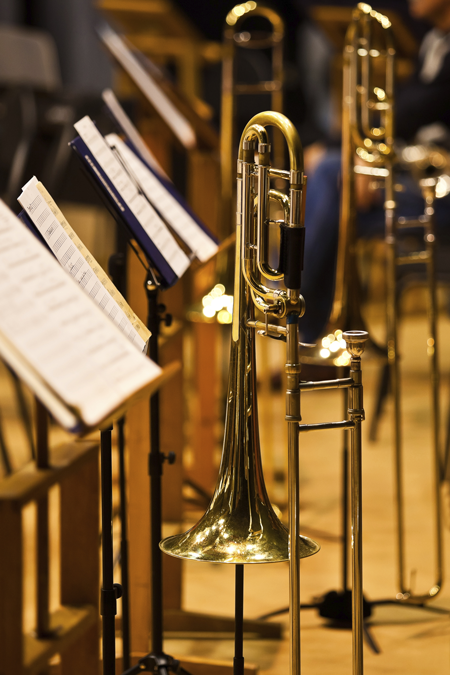 Image of trombones and sheet music on stands