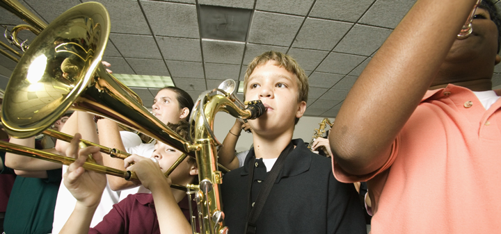 Image of band students playing instruments in a classroom