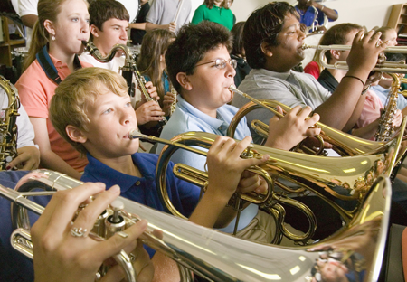 Image of band students playing instruments in a classroom