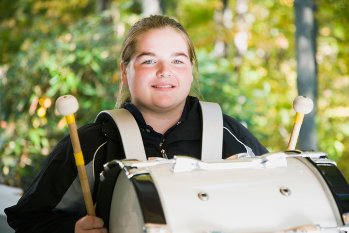Image of a girl with a bass drum on a harness