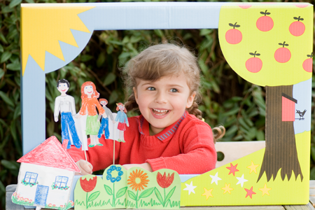 Image of young girl with a shoebox theatre