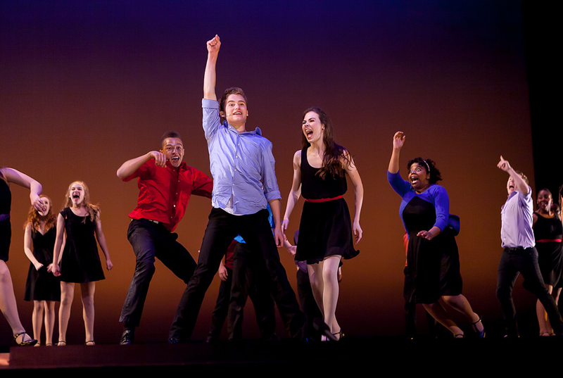 Teacher in front of students on stage