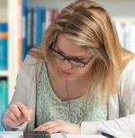 Female student working on a calculator